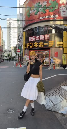 a woman is walking down the street talking on her cell phone and holding a bag