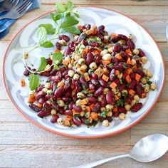 a white plate topped with beans and greens