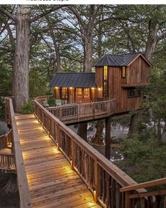 a tree house with stairs leading to it and lights on the porchs above them