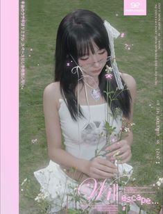 a woman in white dress standing next to flowers