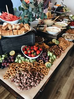 a table filled with lots of different types of food and snacks on it's sides