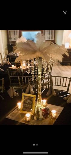 the centerpieces are decorated with feathers and candles