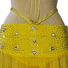 a woman wearing a yellow belly dance skirt with sequins on the bottom and sides