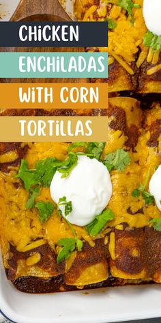 chicken enchiladas with corn tortillas in a white casserole dish