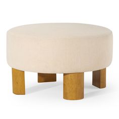 a round ottoman sitting on top of a wooden table