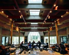 two people sitting at tables in a large room