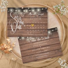 wedding save the date cards with string lights on them and wooden planks in the background