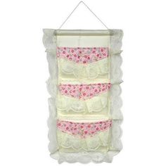 a white wall hanging with pink and white lingeries on it's bottom shelf