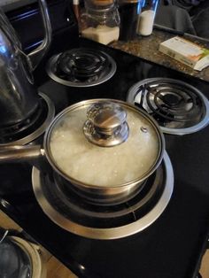 a stove top with a pot on the burner