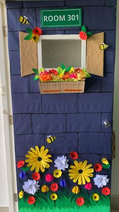 a door decorated with flowers and a sign