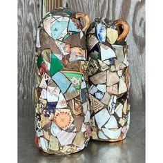 two vases made out of mosaic tiles