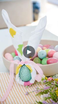 a bowl filled with easter eggs on top of a table