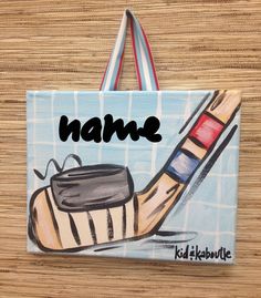 a hand painted bag with a painting of a hockey goalie's boot and name on it