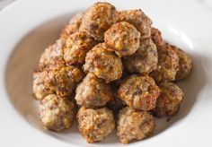 a white bowl filled with meatballs on top of a table