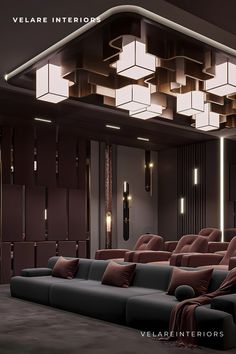 an empty theater with two recliners and several lights on the ceiling above them