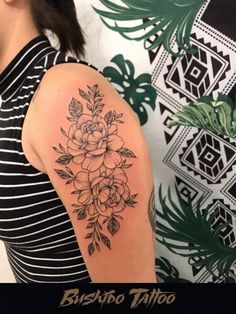 a woman's arm with flowers on it and the words, bushab tattoo