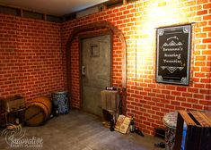 an empty room with red brick walls and wooden barrels