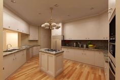 an empty kitchen with wood floors and white cabinets