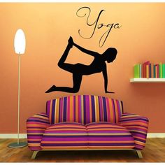 a yoga wall decal with the word yoga on it's side and a woman doing