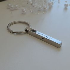 a metal keychain sitting on top of a table