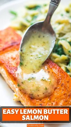 a piece of salmon being drizzled with sauce on top of some pasta