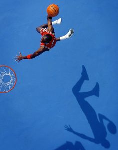 a basketball player jumping up to dunk the ball