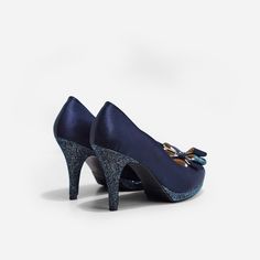 Dream Navy Satin Custom Made Heel is a pair of hand made 3.5 inch satin wedding heels. This pair of peep toe pumps features matching glittery fabric at the platform, heels and ribbon in front. The scalloped sides of this wedding shoe lends a feminine touch to this elegant pair of bridal heels. This shoe comes with 0.25 inch elevated platform and padded footbed for maximum comfort all day long. Do note that our shoe lasts only come with elevated platforms for heel heights 4 inch and above. For lo Glitter Open Toe Wedding Shoes For Evening, Wedding Glitter Accents Open Toe Heels, Glitter High Heel Wedding Shoes, Wedding Open Toe Heels With Glitter Accents, Open Toe Glitter Wedding Shoes For Evening, Glitter Open Toe Wedding Shoes, Open Toe Wedding Heels With Glitter Accents, Elegant High Heel Wedding Shoes With Glitter Accents, Formal Glitter Wedding Shoes With Closed Toe