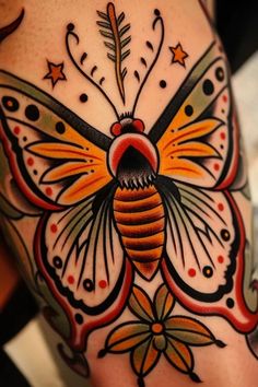 a colorful butterfly tattoo on the back of a woman's arm and leg, with stars around it