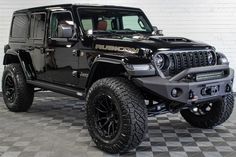 a black jeep is parked on a checkered tile floor in a room with white walls