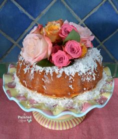 a bundt cake with flowers and coconut on top