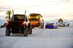 four cars are parked in the snow near each other and one car is off road