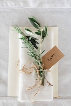 the napkins are wrapped in twine and tied with twine, along with a tag that says tam