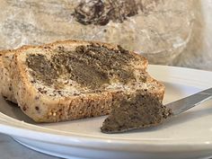 a piece of bread on a plate with a knife