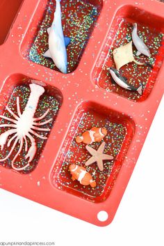 a red tray filled with different types of sea animals and starfishs on it