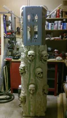 there is a sculpture made out of clay with skulls on the front and back sides