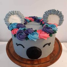 a cake decorated with flowers and an animal's face