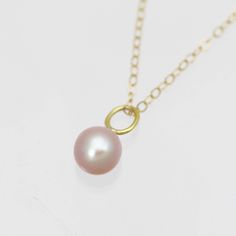 This is a handcrafted 14k yellow gold pearl pendant with a natural 7mm round AA grade cultured freshwater pink pearl. Comes on your choice of a 16 or an 18 inch 14ky gold cable chain. The artist's tag is attached at the clasp. Bail is 3.7mm inner diameter. Comes with a lifetime warranty, polishing cloth, care card, and a gift box. Available with a 5mm pearl: https://www.etsy.com/listing/927500998/pink-pearl-drop-necklace-in-14k-yellow?ref=shop_home_feat_4&frs=1 Available in rose gold: https: Pearl Drop Pendant, Morganite Pendant, Pearl Drop Necklace, Sweet Nothings, Care Card, Yellow Gold Pendants, Pink Pearl, Turquoise Pendant, Drop Necklace