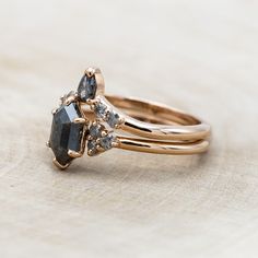 two gold rings with black and white diamonds