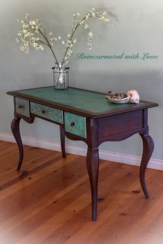 a vase with flowers on top of a wooden table