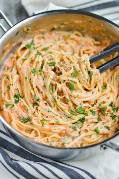 a pan filled with pasta and sauce on top of a table