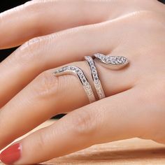 The snake is one of the oldest and most widespread mythological symbols, a symbol of transformation, rebirth and immortality. Crafted in sterling silver, the ring is set with glittering white stones as skin and decorated with smaller stones to add its spark. If you are interested in snake jewelry, just add this ring to your jewelrybox.Carat Weight: 1.471 ctStone Size: 1.9,1.7,1.5,1.3 mmStone Type: Jeulia® StoneNumber of Stones: 42 Stone Color: Diamond WhiteStone Shape: RoundWeight: 6 gWidth: 2.6 Elegant Snake-shaped Jewelry With Diamond Accents, Snake-shaped Diamond Jewelry For Anniversary, Diamond Snake Shape Jewelry For Anniversary, Snake Shape Diamond Jewelry For Anniversary, Silver Crystal Ring With Pave Setting, Diamond Snake Ring, Open Style, Elegant Snake-shaped Rings For Anniversary, Diamond Snake Open Ring Fine Jewelry, Diamond Snake Open Ring In Fine Jewelry Style