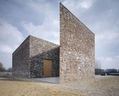 an old brick building with two doors on the outside