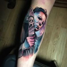 a man with a knife tattoo on his leg