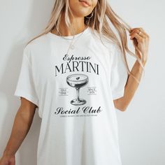 This Espresso Martini Social Club T-Shirt is perfect as a gift, a girls trip or just for everyday! Welcome to my store! Everyone needs the perfect t-shirt to complement an everyday, laid-back look. The ideal top for so many occasions, this lightweight cotton tee will keep you comfy and looking smart. * 100% combed and ring-spun cotton (Heather colors contain polyester) * Fabric weight: 4.2 oz/yd² (142 g/m²) * Pre-shrunk fabric * Side-seamed construction * Shoulder-to-shoulder taping * Blank prod White Short Sleeve T-shirt For Brunch, Short Sleeve Screen Print Tops For Brunch, Graphic Tee T-shirt For Brunch With Short Sleeves, Graphic Tee For Brunch With Short Sleeves, Short Sleeve T-shirt With Screen Print For Brunch, Short Sleeve Screen Print T-shirt For Brunch, Funny Print Short Sleeve T-shirt For Brunch, Trendy White T-shirt For Brunch, Trendy Short Sleeve Shirt For Brunch