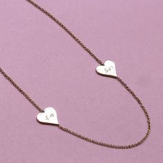 Add a romantic touch to your layered necklaces with this dainty necklace made of 14k gold. Two hearts engraved with your loved ones names makes a perfect and personal gift. This fine necklace is easy to wear with everything, fits perfectly with other necklaces, and also looks fabulous on it's own. This is a must-have necklace. All features can be customized! Talk to us, we love making custom designs. Our jewelry is carefully handmade in our atelier Our diamonds are conflict free To order by phone click here>> +972(0)722991000 Rose Gold Name Necklace With Delicate Chain For Anniversary, Elegant Customizable Heart Necklace For Anniversary, Customizable Elegant Charm Necklace For Valentine's Day, 14k Gold Double Heart Engraved Necklaces, 14k Gold Double Heart Engraved Necklace, Elegant Double Heart Engraved Name Necklace, Dainty Engraved Necklace For Valentine's Day, Personalized Yellow Gold Double Heart Necklace, Elegant Engraved Double Heart Name Necklace