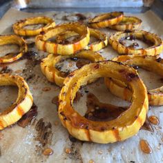 several peeled bananas sitting on top of a baking sheet covered in oil and seasoning