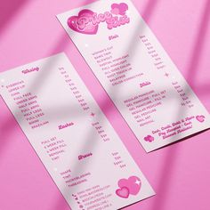 two pink and white menus with hearts on them sitting next to each other in front of a pink background