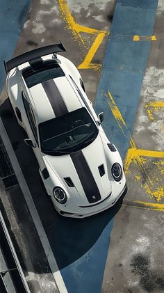 a white and black sports car parked on the street