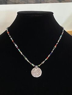 "Minimalistic beads with quarter-sized coin pendant sending a message of love, faith, peace and spirit. Beads are in southwestern colors and the tiny size offers a minimal boho look that can be on it's own our easily layered. The perfect Urban Boho style. Necklace length is 18\". Bead mix: Ancient (over 2,000 yrs. old) Djenne beads, African trade beads, and Roman glass beads. Other beads include, Labradorite, faceted hematite, genuine turquoise, Venetian glass, and TOHO seed beads. Free gift of One-of-a-kind Medallion Necklace For Festivals, Handmade Spiritual Round Disc Necklace, Medallion Necklace With Coin Pendant For Festivals, Multicolor Bohemian Medallion Beaded Necklaces, Multicolor Bohemian Medallion Beaded Necklace, Multicolor Spiritual Beaded Necklaces Nickel Free, Spiritual Festival Necklaces With Coin Pendant, Spiritual Multicolor Nickel-free Beaded Necklace, Handmade Southwestern Medallion Necklaces