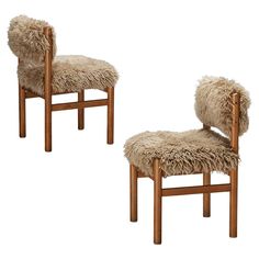 two wooden chairs with sheep fur on them